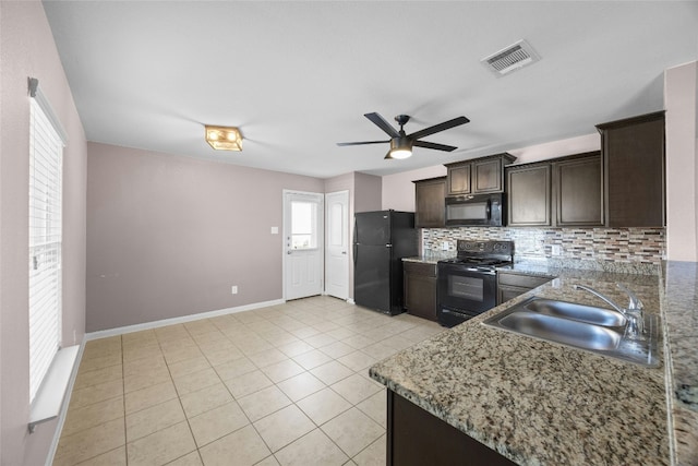 kitchen with light tile patterned floors, visible vents, a sink, black appliances, and backsplash