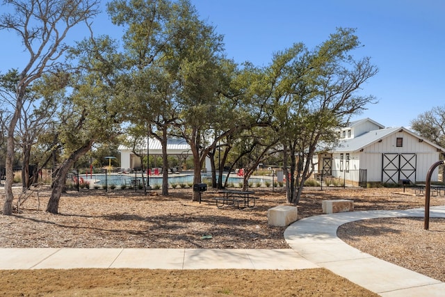 view of property's community featuring fence and a pool