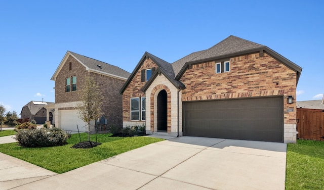 view of front of house with brick siding, roof with shingles, stone siding, driveway, and a front lawn