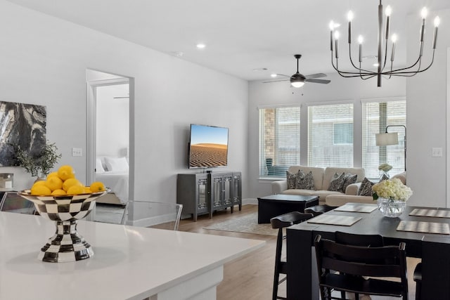 living room with light wood-style floors, ceiling fan, baseboards, and recessed lighting