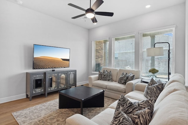 living area featuring recessed lighting, visible vents, a ceiling fan, wood finished floors, and baseboards