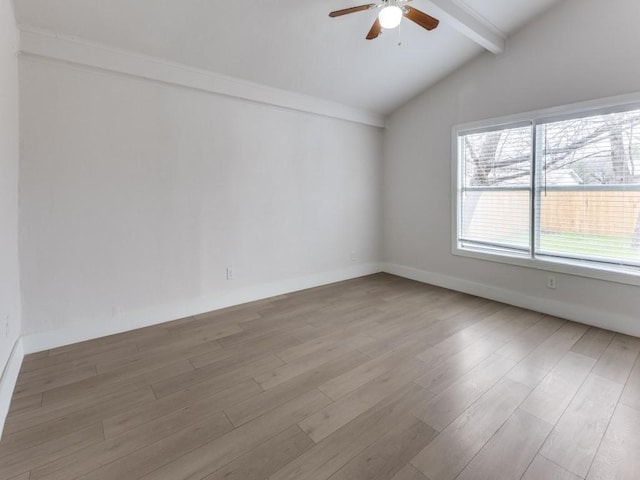 empty room featuring lofted ceiling with beams, baseboards, light wood-style flooring, and a ceiling fan