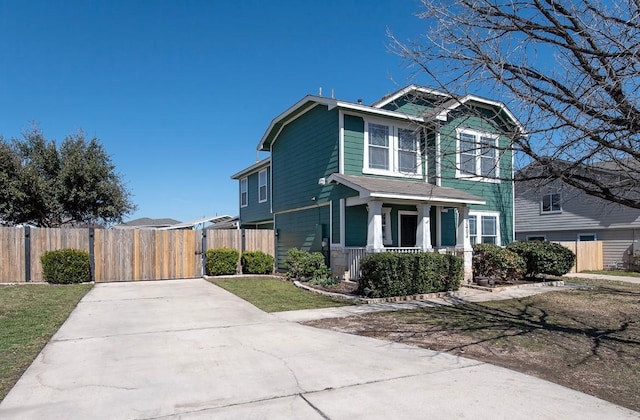 view of front of house with a porch, a gate, and fence