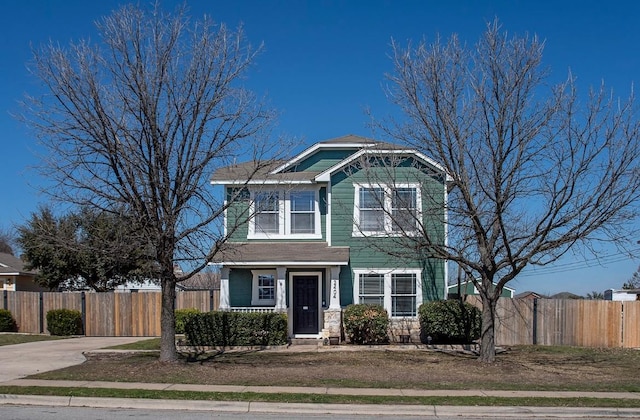 view of front of property featuring fence and driveway