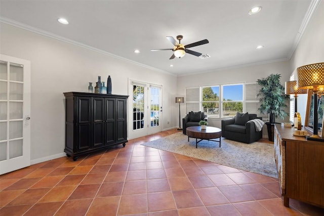 living area with crown molding, recessed lighting, ceiling fan, dark tile patterned floors, and baseboards