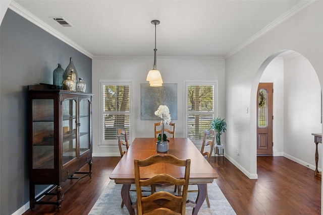 dining space featuring arched walkways, dark wood finished floors, visible vents, and plenty of natural light