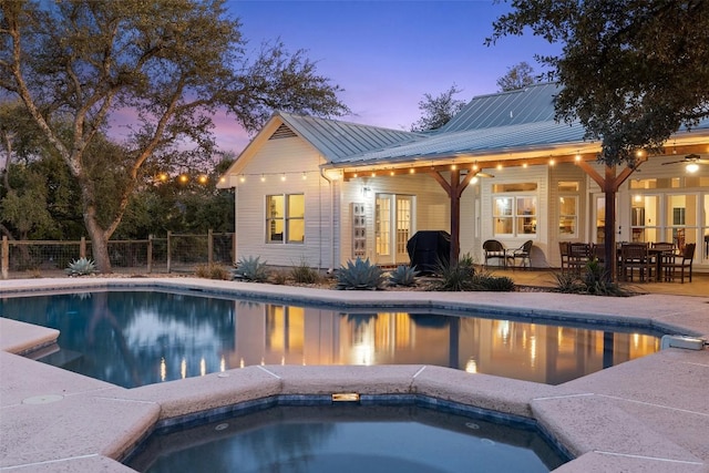 view of pool with a fenced in pool, fence, a patio, and an in ground hot tub