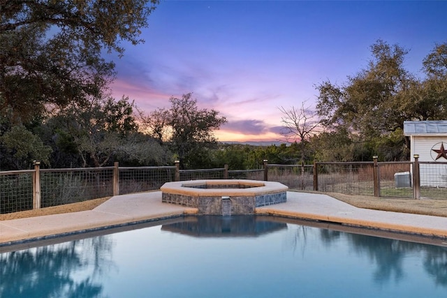 view of pool featuring a fenced in pool, fence, and an in ground hot tub