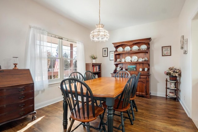 dining room with dark wood-type flooring and baseboards