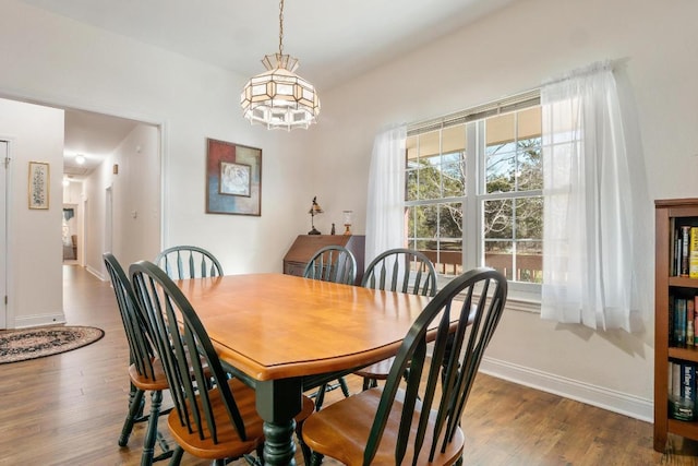 dining room featuring dark wood-type flooring and baseboards