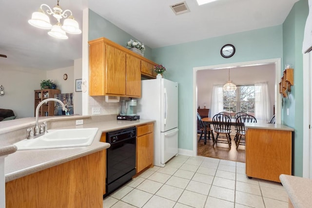 kitchen with a sink, visible vents, light countertops, dishwasher, and decorative light fixtures