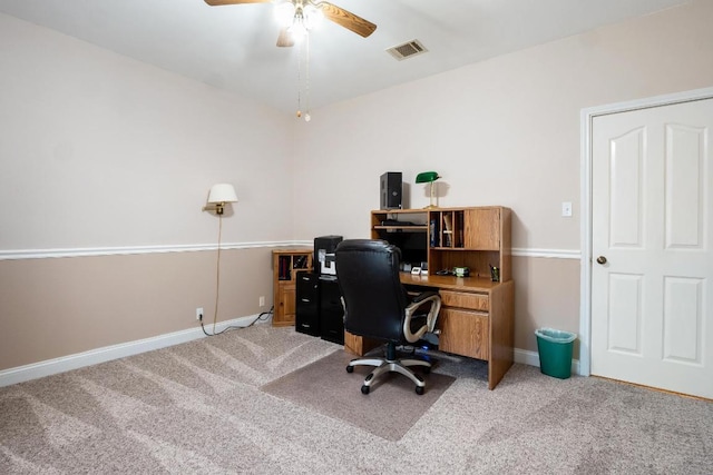 home office with a ceiling fan, carpet, visible vents, and baseboards