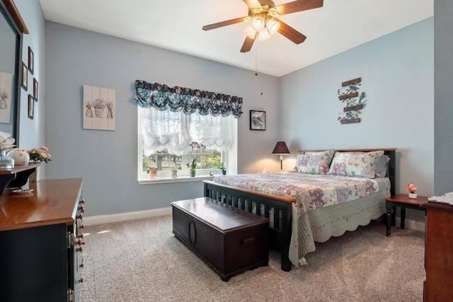 carpeted bedroom featuring ceiling fan and baseboards