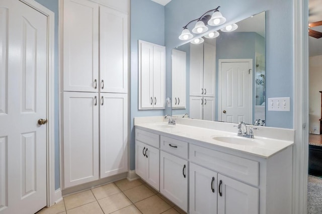 full bath featuring double vanity, a sink, and tile patterned floors