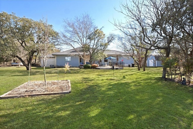 view of yard with an outdoor structure and a storage unit