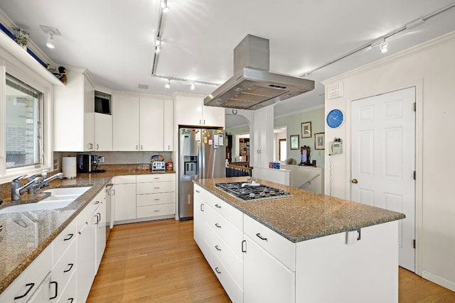 kitchen with a sink, white cabinetry, a large island, appliances with stainless steel finishes, and island exhaust hood