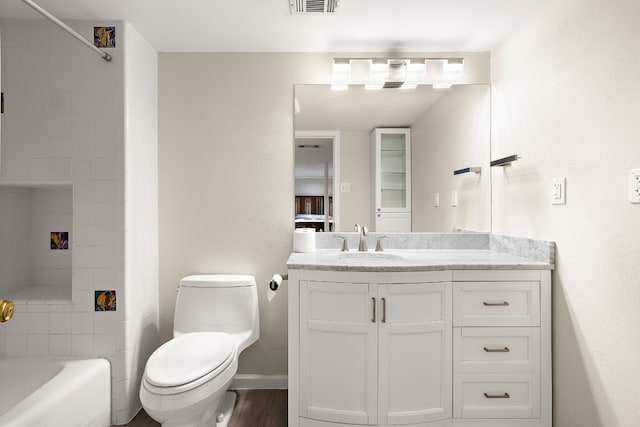 full bathroom featuring visible vents, baseboards, bathing tub / shower combination, toilet, and vanity