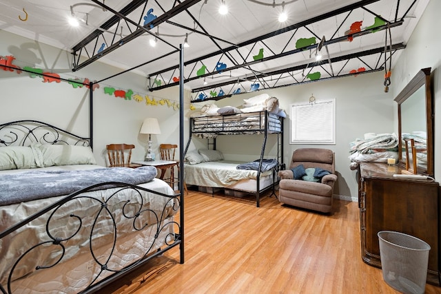 bedroom with baseboards and wood finished floors