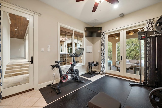 exercise area with baseboards, a ceiling fan, and french doors