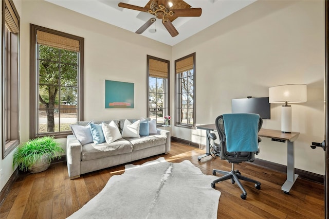 office space featuring wood-type flooring, baseboards, and ceiling fan