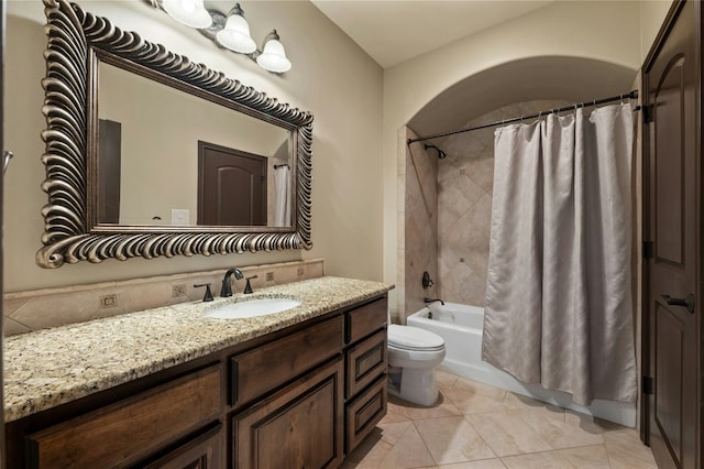 full bath featuring toilet, tile patterned floors, shower / tub combo with curtain, and vanity