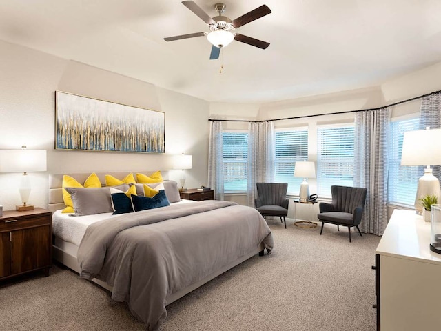 bedroom with light carpet and a ceiling fan