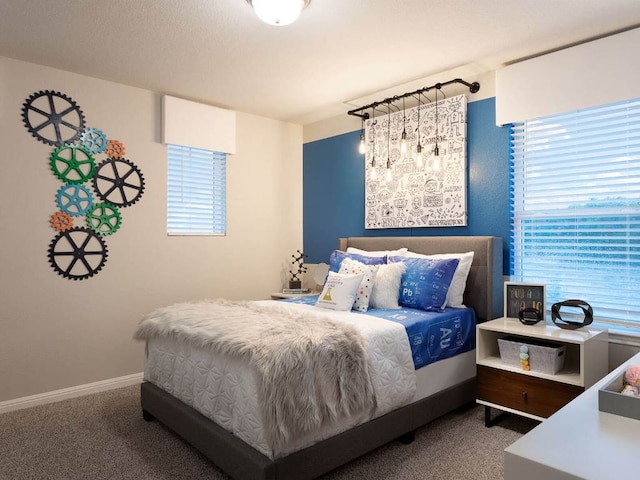 carpeted bedroom featuring multiple windows and baseboards