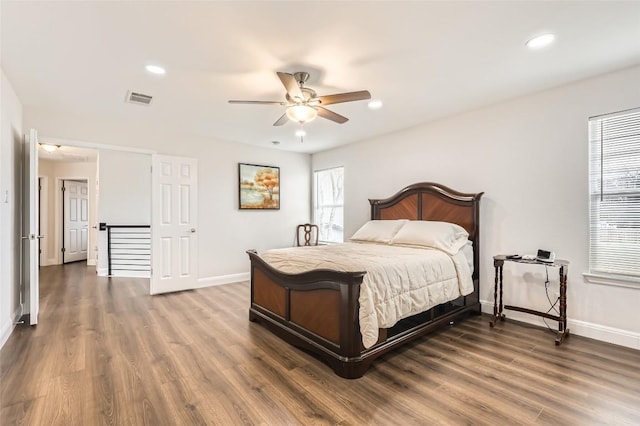 bedroom featuring dark wood-style flooring, recessed lighting, visible vents, and baseboards