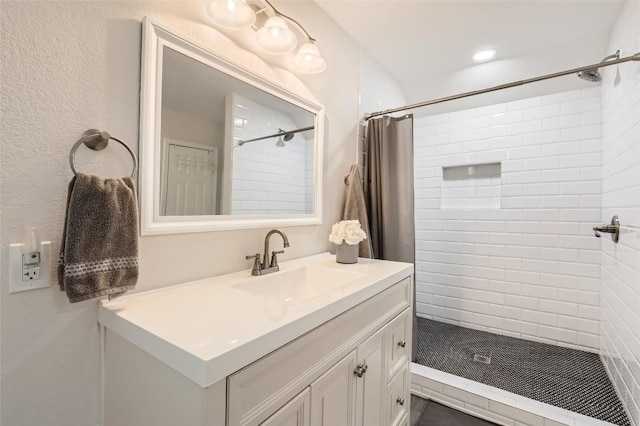 full bathroom with a shower stall and vanity