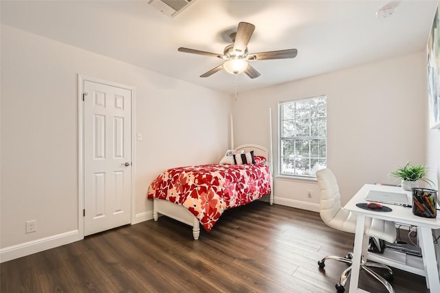 bedroom featuring dark wood-style floors, visible vents, and baseboards