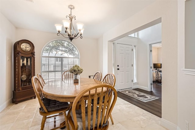 dining room featuring a chandelier and baseboards