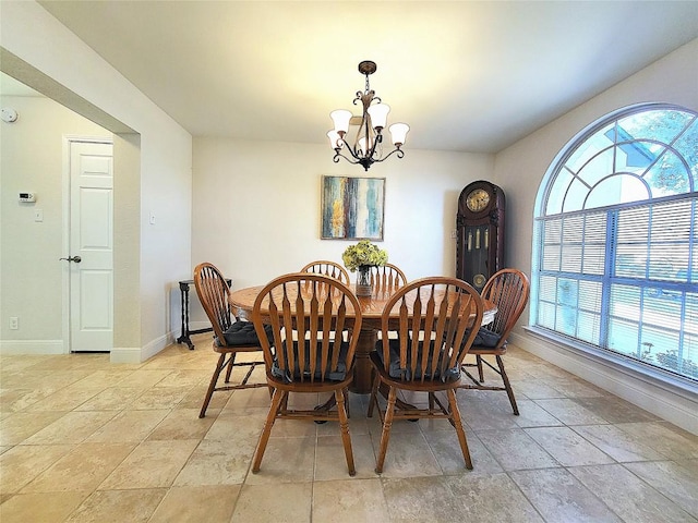 dining area featuring an inviting chandelier and baseboards