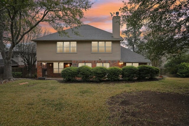 3304 Mulberry Creek Dr, Austin, TX 78732 - rear view of house with a chimney, brick siding, and roof with shingles