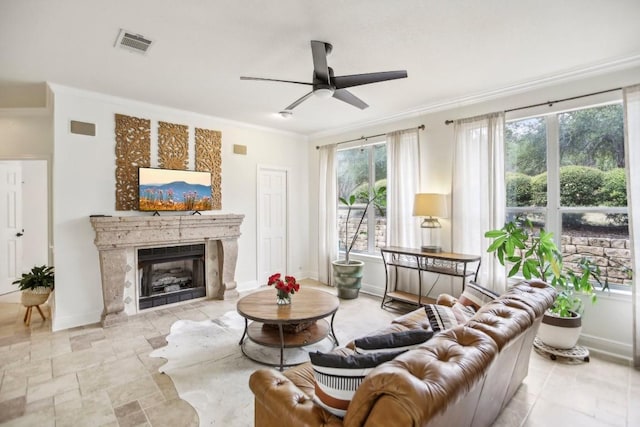 3304 Mulberry Creek Dr, Austin, TX 78732 - living area featuring crown molding, ceiling fan, a premium fireplace, and stone finish flooring