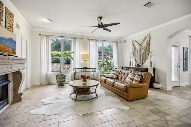 3304 Mulberry Creek Dr, Austin, TX 78732 - living room with a fireplace, arched walkways, ceiling fan, healthy amount of natural light, and crown molding