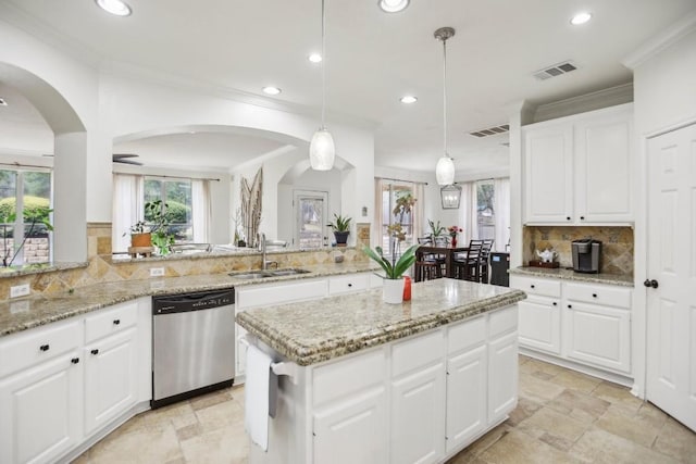 3304 Mulberry Creek Dr, Austin, TX 78732 - kitchen with dishwasher, recessed lighting, stone tile flooring, tasteful backsplash, and arched walkways