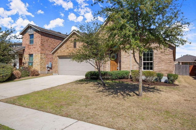 traditional-style home featuring a garage, driveway, brick siding, and fence