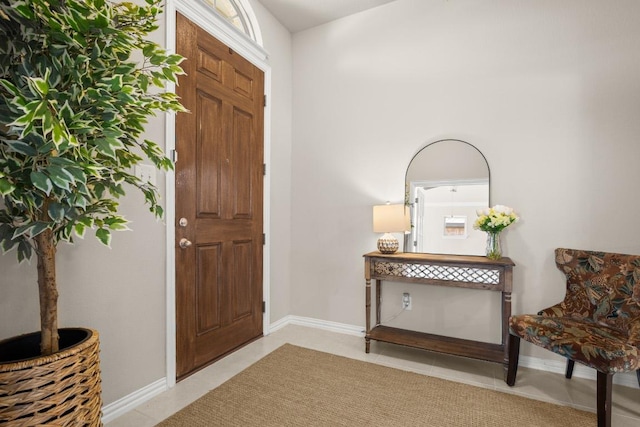 entrance foyer featuring light tile patterned floors and baseboards