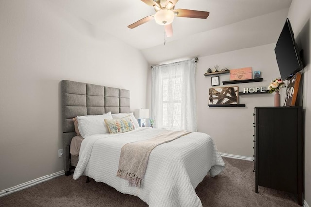 bedroom featuring baseboards, vaulted ceiling, a ceiling fan, and dark colored carpet