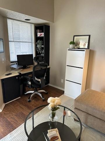 office space with dark wood finished floors and baseboards