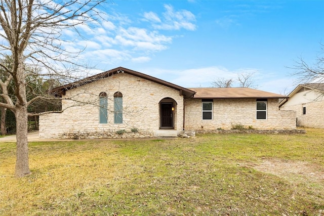 view of front of home with stone siding and a front yard