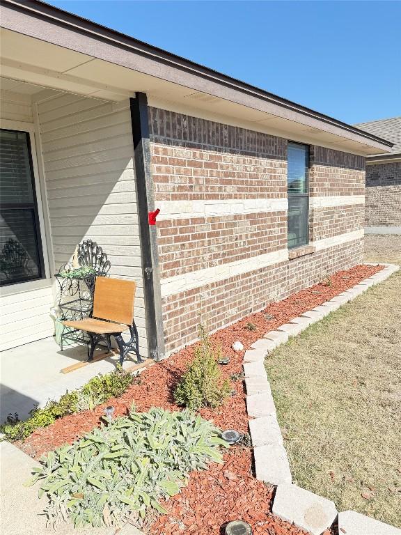 view of side of property featuring brick siding