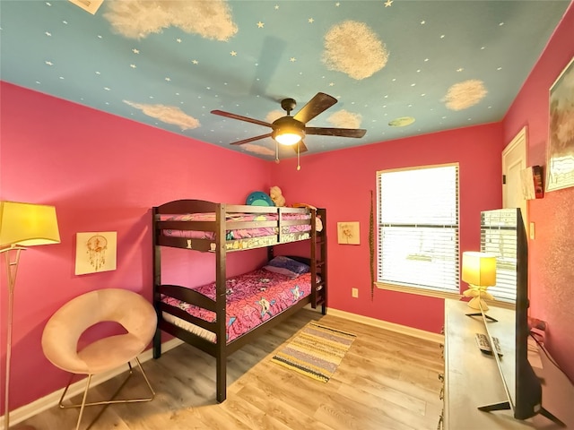 bedroom featuring ceiling fan, wood finished floors, and baseboards