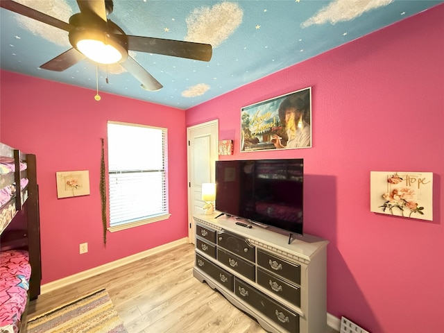 bedroom with ceiling fan, light wood-type flooring, and baseboards