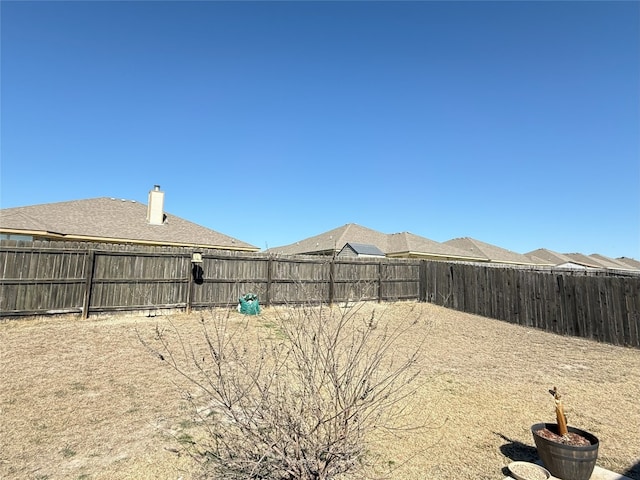 view of yard with a fenced backyard