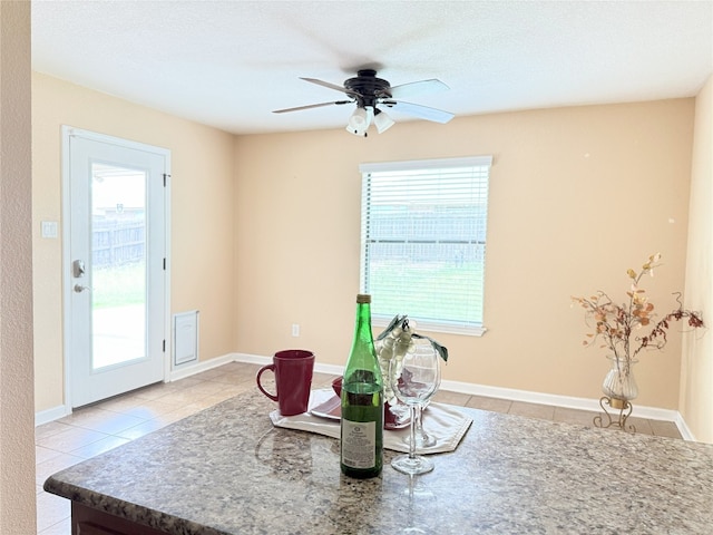 living area featuring ceiling fan and light tile patterned floors