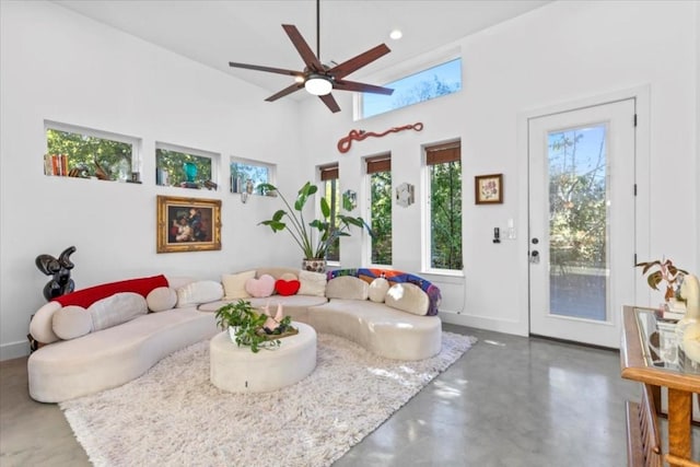 2115 Uphill Ln Unit A, Austin, TX 78741 - living area with recessed lighting, concrete flooring, ceiling fan, baseboards, and a towering ceiling