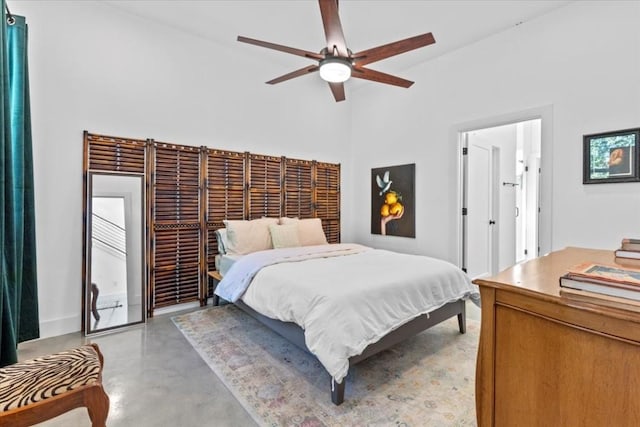 2115 Uphill Ln Unit A, Austin, TX 78741 - bedroom featuring finished concrete flooring, a ceiling fan, high vaulted ceiling, and baseboards