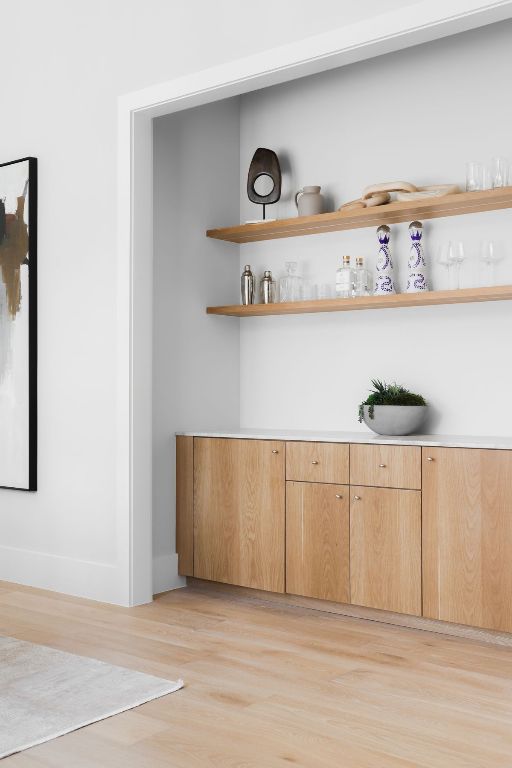 bar featuring light wood-style flooring and baseboards