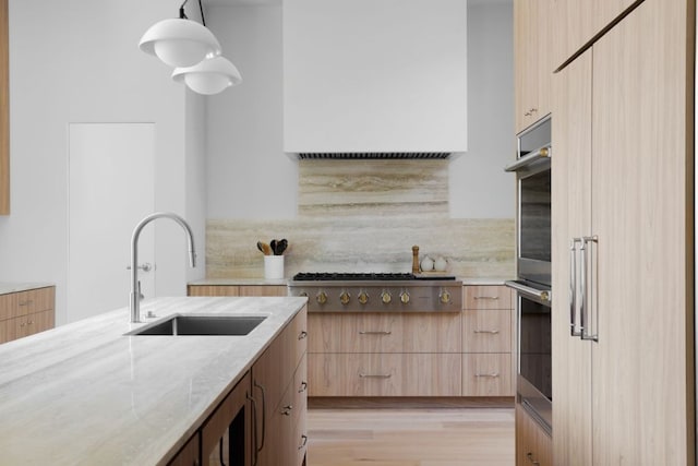 3614 Murillo Cir, Austin, TX 78703 - kitchen featuring light brown cabinetry, light stone countertops, modern cabinets, tasteful backsplash, and stainless steel appliances